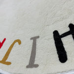 Load image into Gallery viewer, Close-up of the texture and the prints of letters H, I, and J on a children's round carpet with colorful letters of the alphabet arranged in a circular pattern

