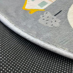 Load image into Gallery viewer, Sticky dots for additional safety on the underside of a children's round carpet with a small town design
