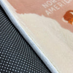 Load image into Gallery viewer, Safety sticky dots underneath a children's carpet with world map and animal illustration on a white background
